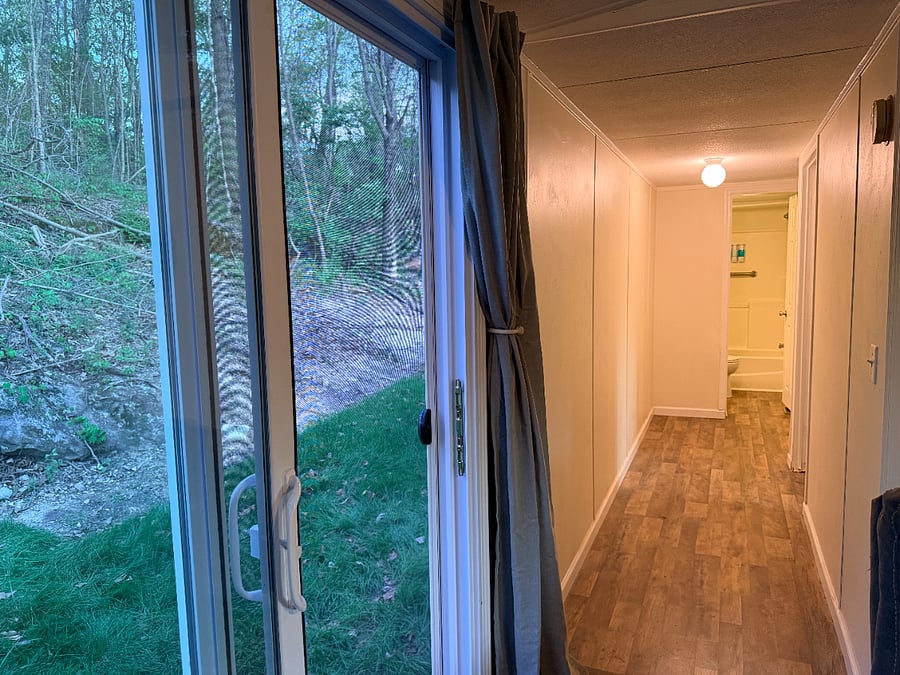 Hallway to 2nd and 3rd bedrooms, and 2nd bathroom. View of the backyard.
