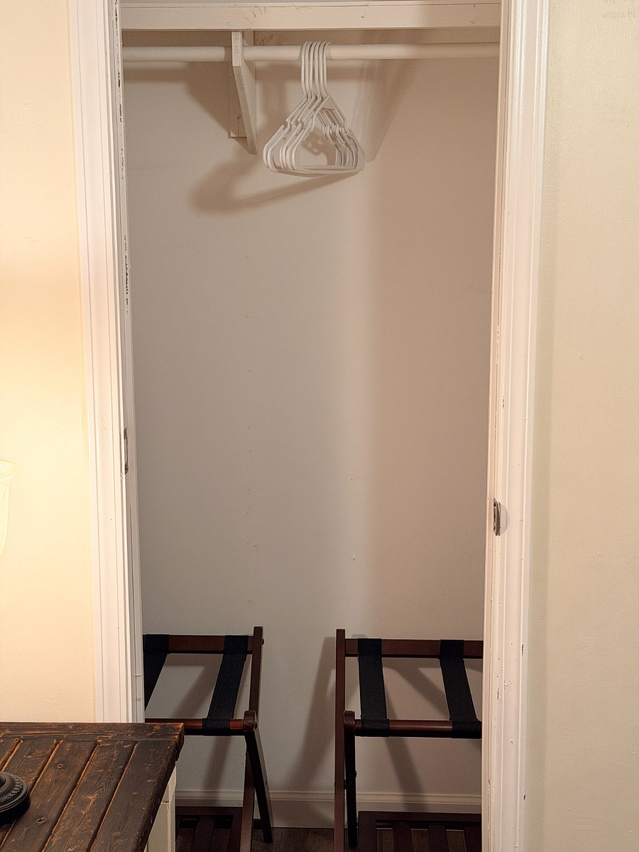 The third bedroom closet has two luggage racks.