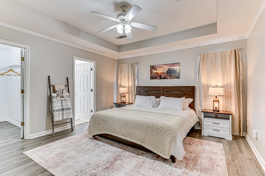 Master bedroom with king size bed, dresser, working desk, tv with Roku stream, and walk in closet.