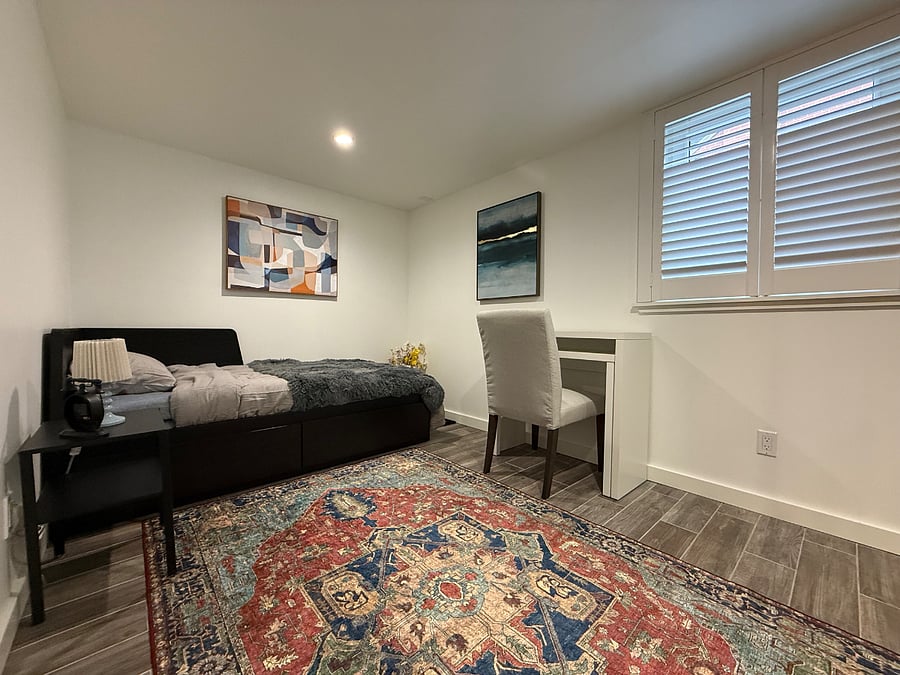 Second bedroom (11' x 9') with a pull-out bed for two people, a pull-out desk, and an air purifier.