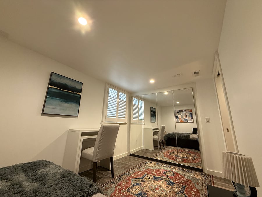 Second bedroom (11' x 9') with a pull-out bed for two people, a pull-out desk, and an air purifier.