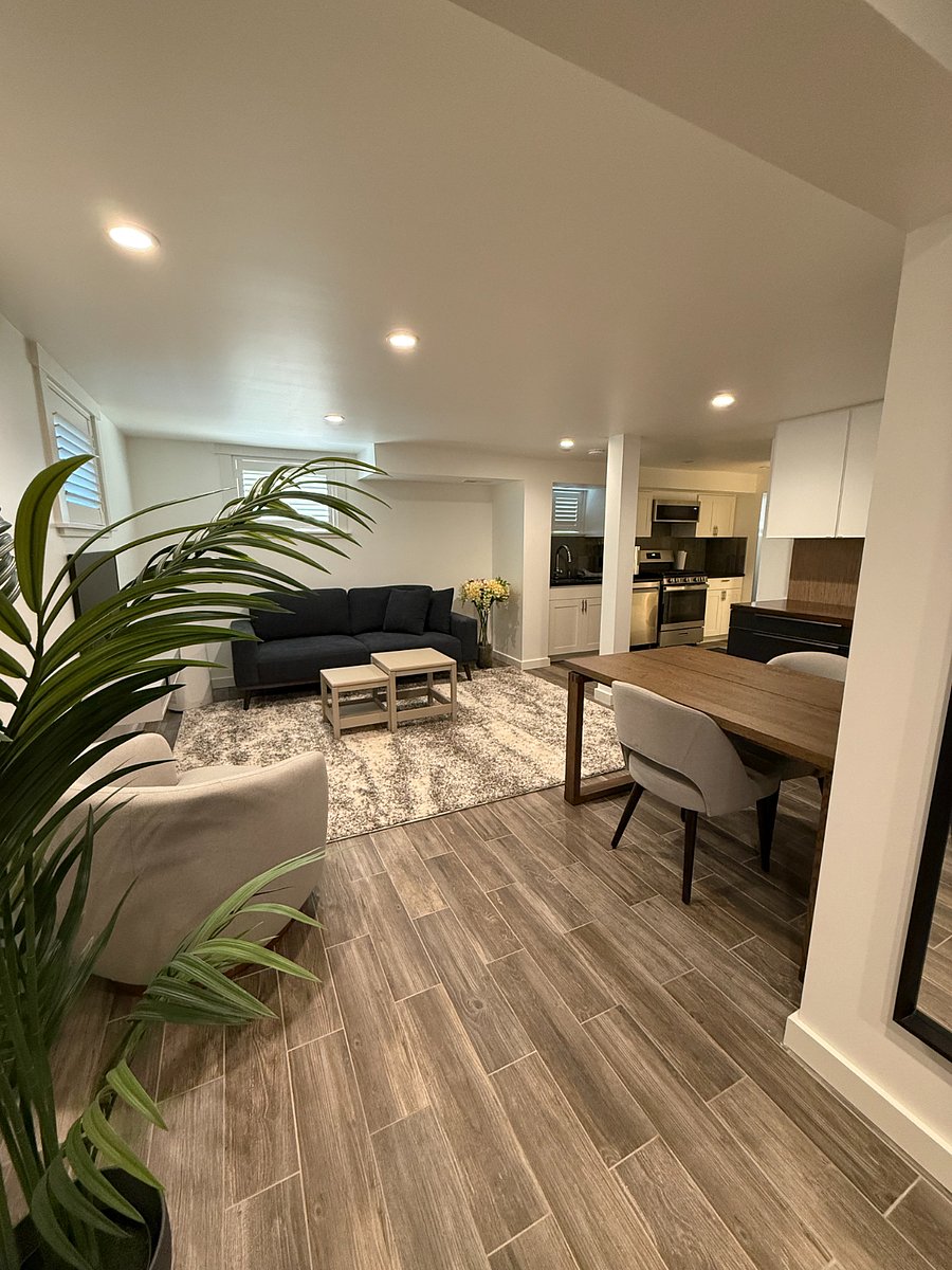 Open layout with a living room, dining area, full-size kitchen, and a dedicated coffee bar.