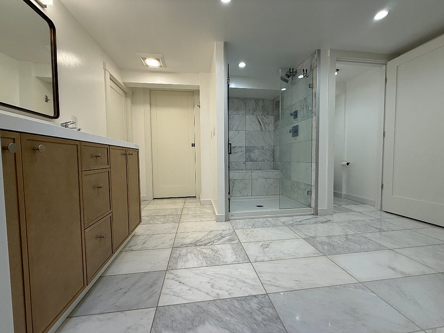 Spacious bathroom (10' x 9') with heated floors, a double vanity, an enclosed toilet, and a closet.