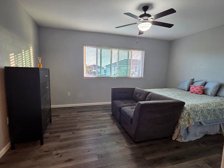 Primary bedroom with private bathroom, King size bed, loveseat, and walk-in closet, over looking garden and Giant Calitrope Monarch Butterfly Sanctuary