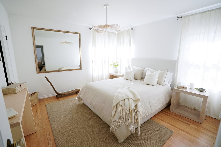 Primary bedroom with queen bed, natural light, and calming neutral finishes.