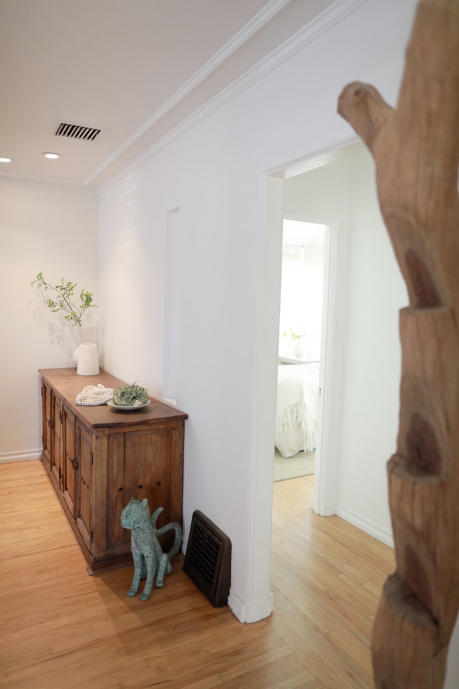 Additional living room angle showcasing art, storage, and natural light.