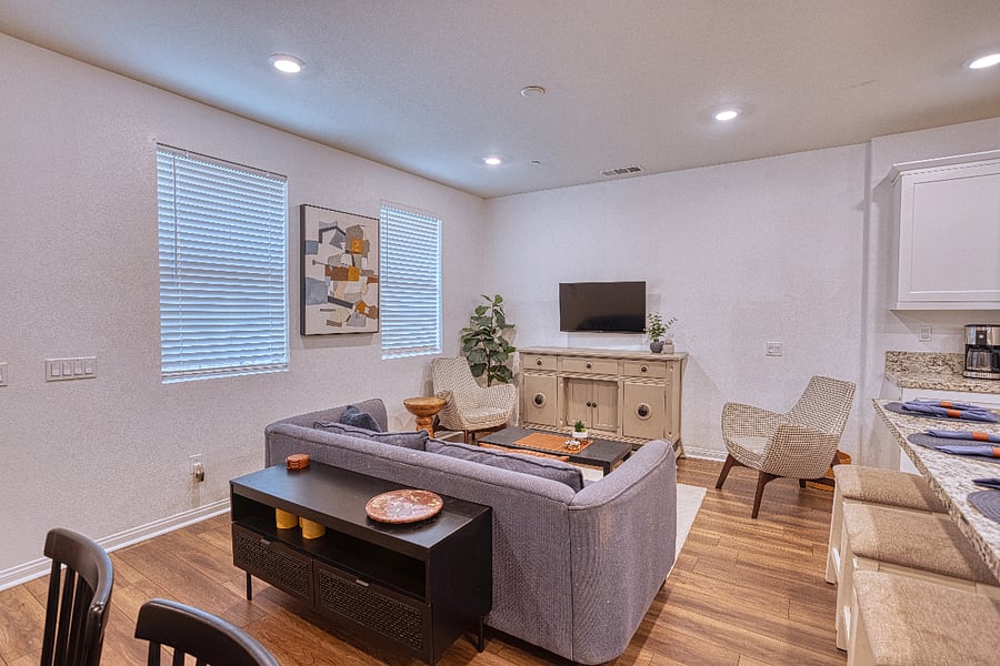 Relax in this airy, modern living room after a day of exploring Santa Clarita. With plenty of seating and a flat-screen TV, its the perfect spot to unwind, stream your favorite shows, or plan your next trail adventure.