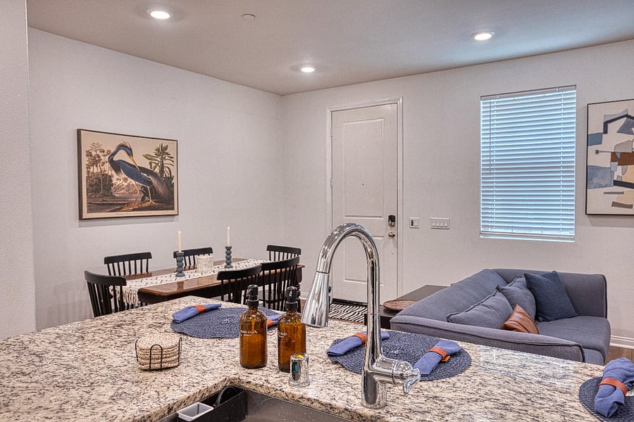 A view from the chefs kitchen overlooking the dining and living areas. This open-concept layout is perfect for entertaining, allowing you to prep meals while staying connected with family and friends in a bright, modern setting.