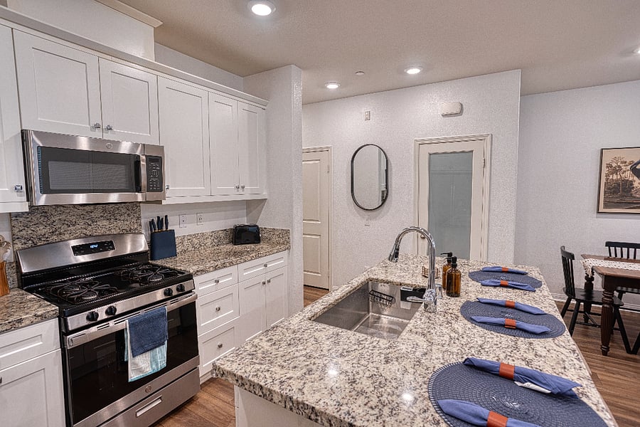 The heart of the home features high-end granite countertops and a sleek gas range. Whether you're whipping up a quick breakfast or a full family dinner, this chef-ready kitchen provides everything you need for a comfortable stay