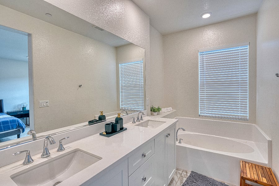 Experience the convenience of a dual-sink vanity and a deep soaking tub in our primary en-suite. This bright, modern bathroom is stocked with essentials to ensure your morning routine is as relaxing as your evening soak.