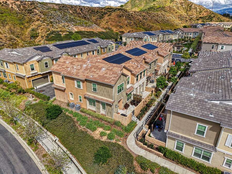An aerial view of our modern Valencia townhome community. Nestled against rolling hills, this quiet neighborhood offers a peaceful escape with easy access to local trails and all the amenities you need for a perfect Southern California stay.