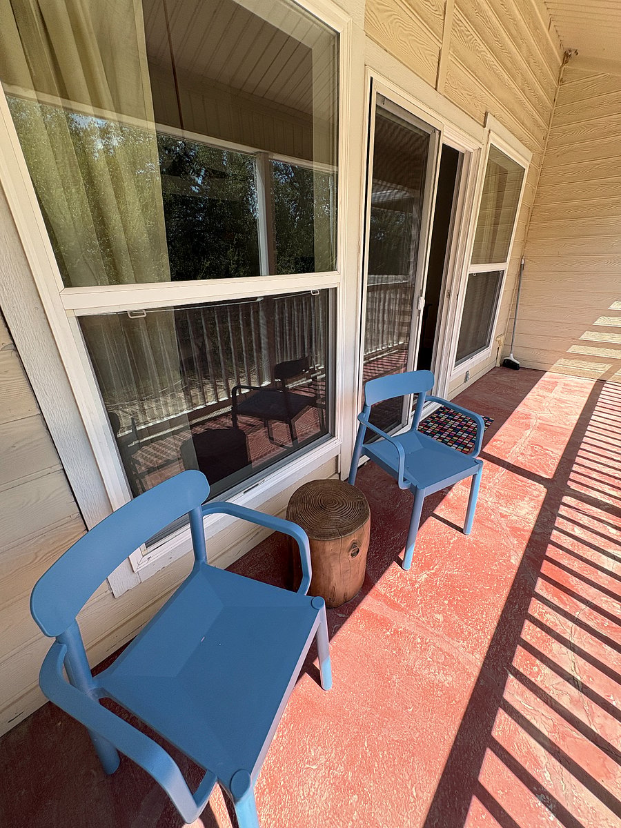 The second-story balcony is covered, 17 feet long, and mostly east-facing; looking out to the trees in the park.