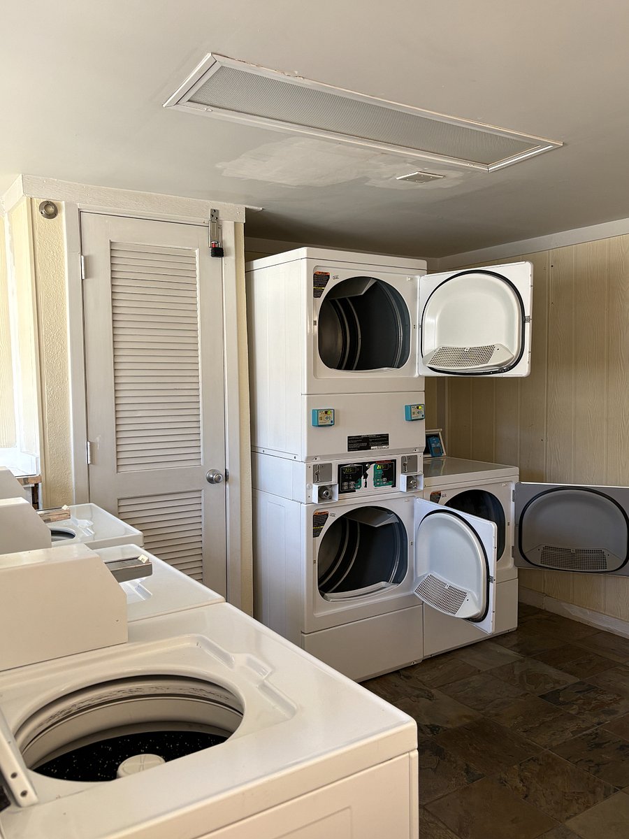 The condo complex has a community laundry room near the pool.
