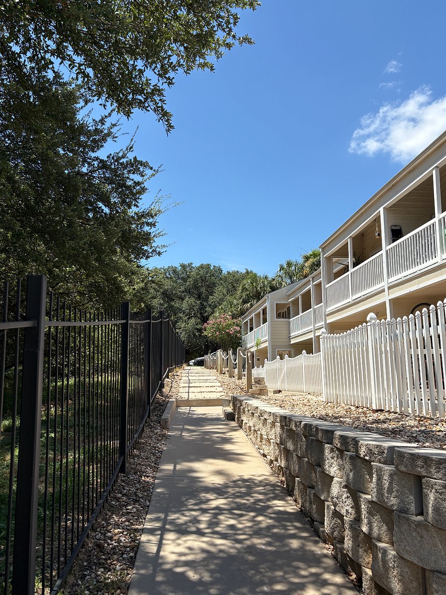 The path that runs along the eastside of the condo complex to the lawn that leads to Ladybird Lake.