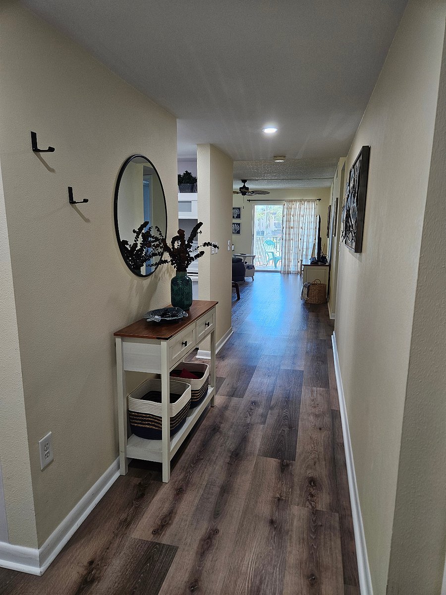 Welcome to your condo. Hooks, mirror, and table to drop your keys