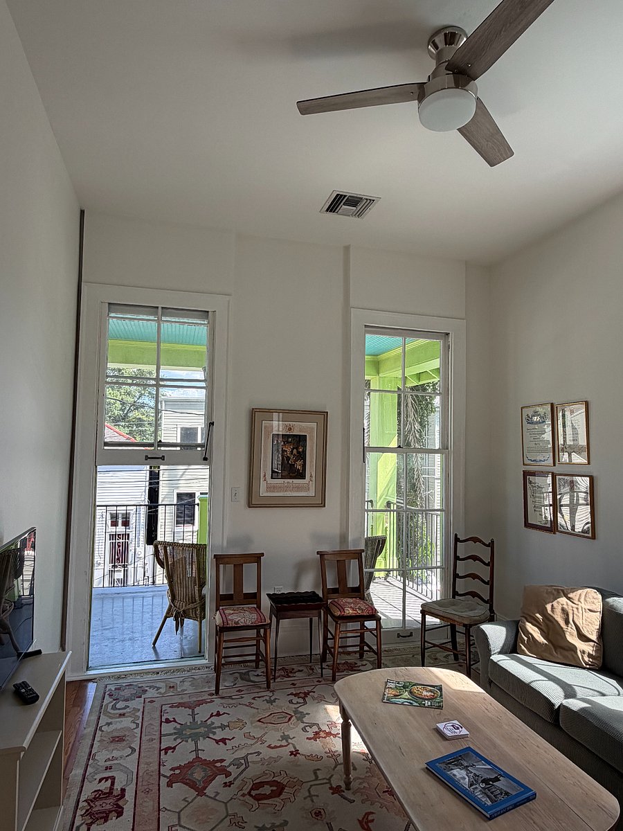 Tall windows open to the front balcony