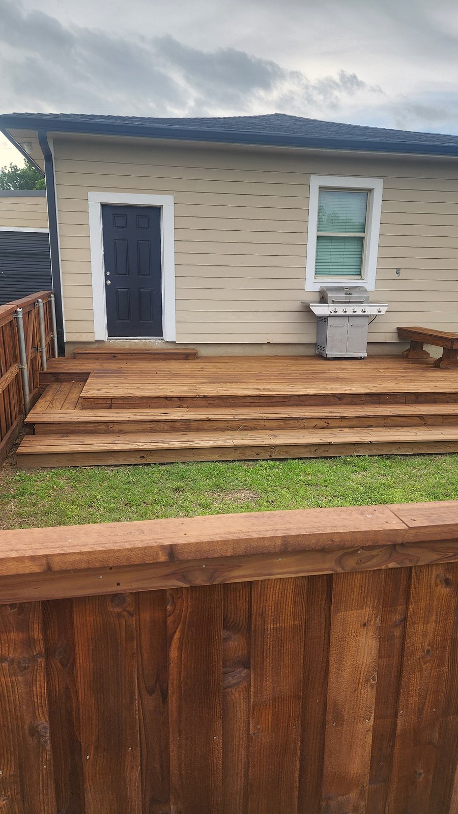 fenced in backyard with deck