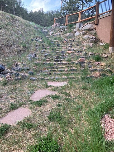 Rock steps lead from the driveway to your separate entrance.
