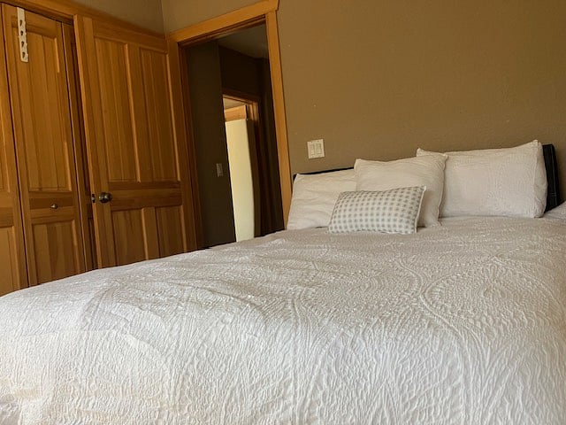 Queen bedroom view with folding closets
