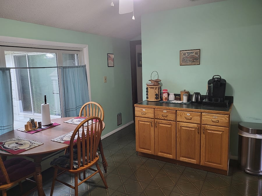 KITCHEN: TABLE, CABINETS, COFFEE BAR