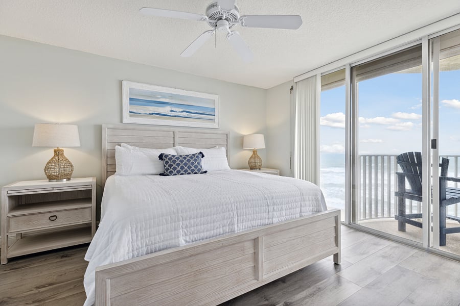 Master bedroom with a luxurious king-size bed, and private balcony access.