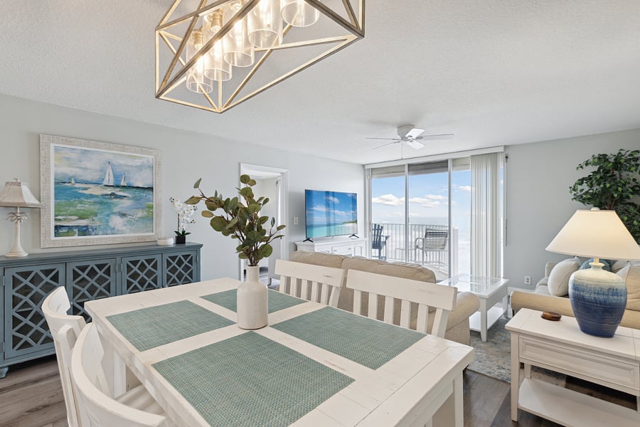 Elegant dining room leading to the living area and balcony.