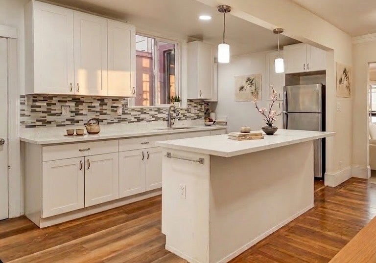 Small 4 person kitchen table located in bottom right corner of this photo.