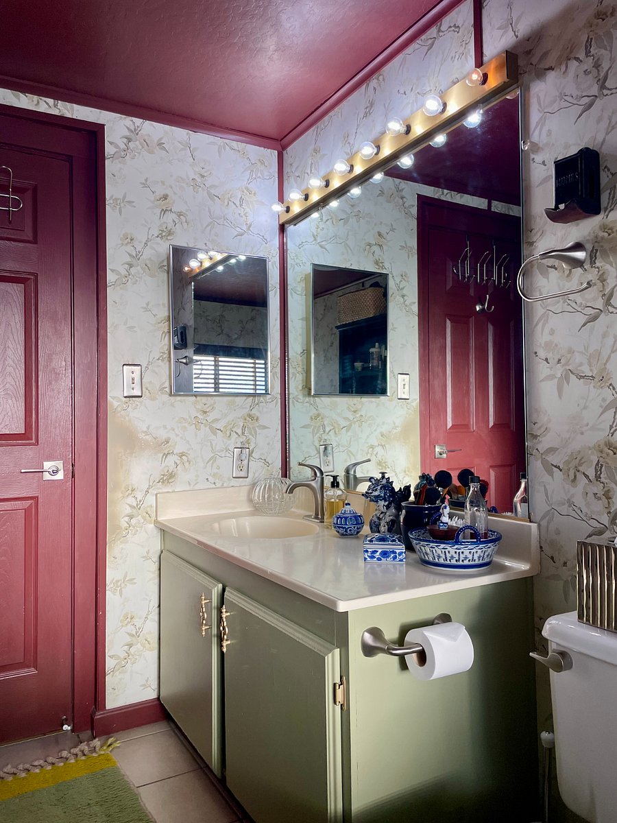 Vanity with deep cabinets to house large, bulky items. Bright makeup lights and a wide mirror over the sink. Wall medicine cabinet to store small items. Mirrored door swings out as a rearview mirror.