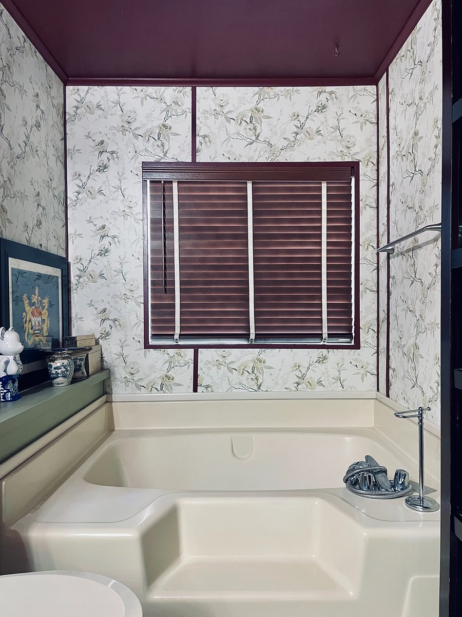 Low but wide soaking tub. Single step to enter. Storage ledge to keep things dry.