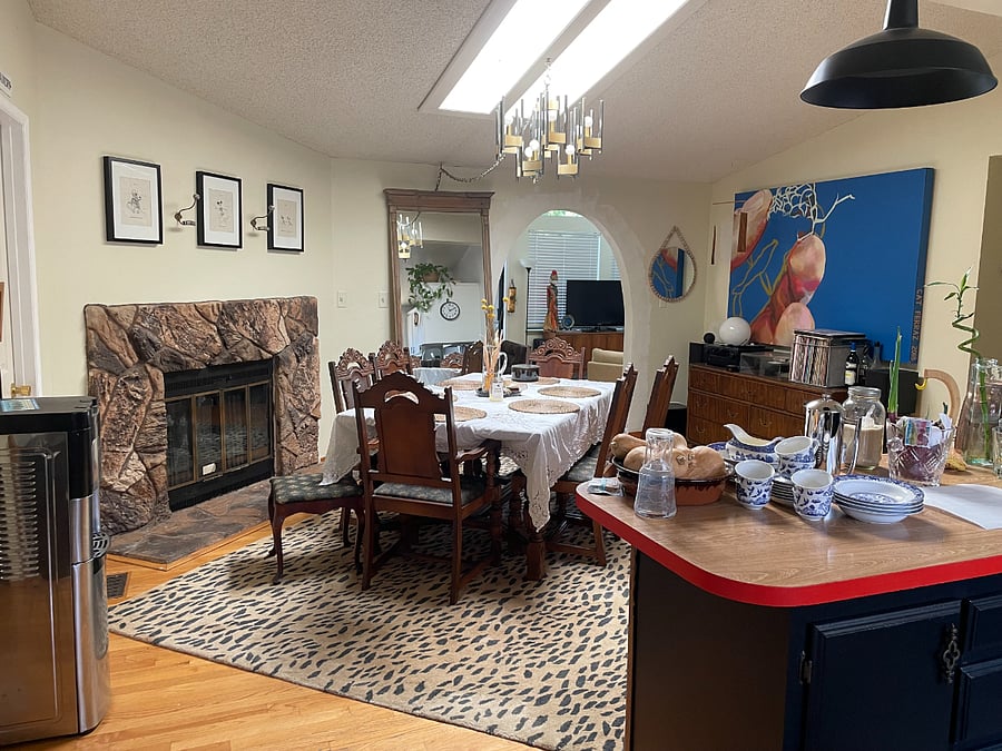 The dining room is at the heart of the house. The open plan kitchen overlooks it on west end (afternoon light) and the second living room is through the arch. The laundry room door is on another side as is a hallway leading to the bedrooms.