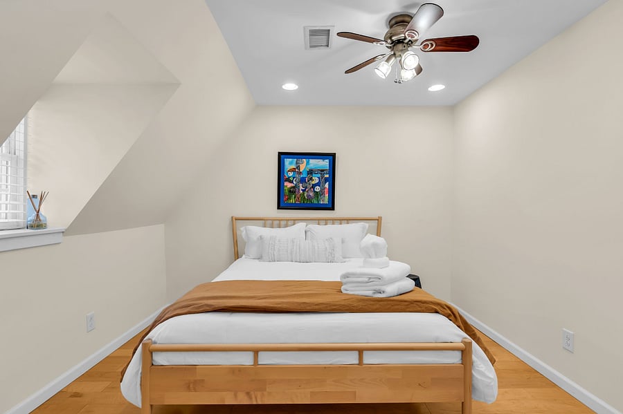 Light and open bedroom with queen bed. 