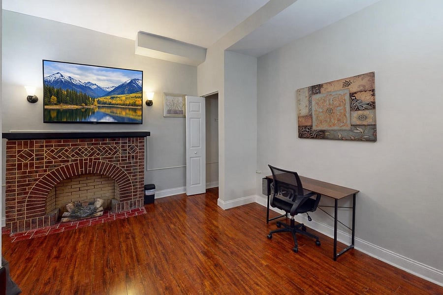 Large room with a closed fireplace, double window for lighting and closet space for easy access storage.