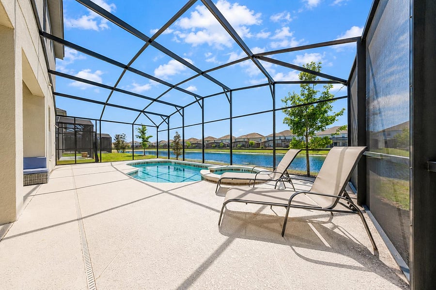 Screened-in lanai with an in-ground pool, spa, and wide deck space for lounging plus peaceful water views.