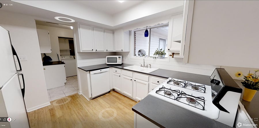 U-shaped kitchen with ample cabinet storage, generous counter space, and a window over the sink for added light.