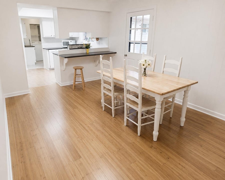 Dining area with a full-size table, open sightlines to the kitchen, and a breakfast bar for extra seating.