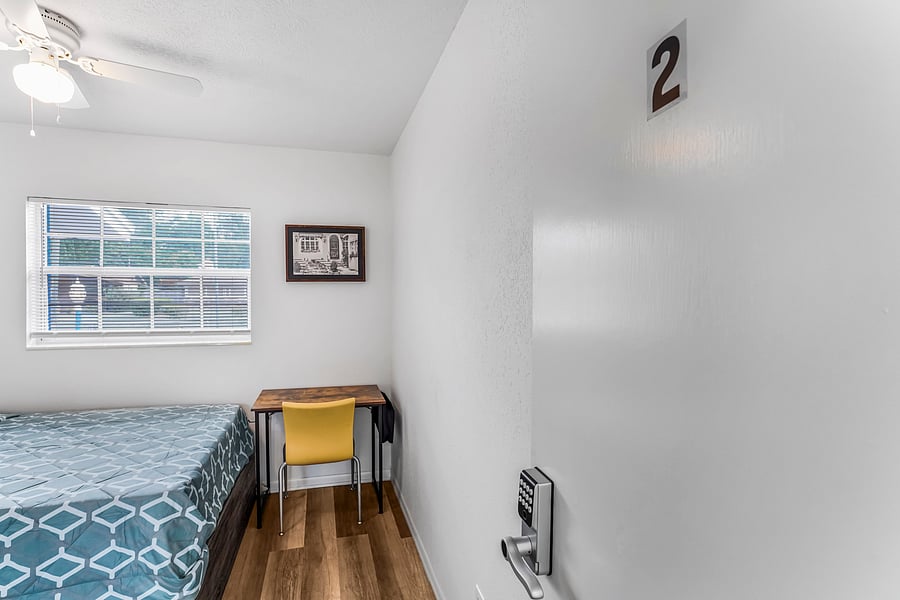 Cozy bedroom with a desk work station, full size bed and comfortable closet