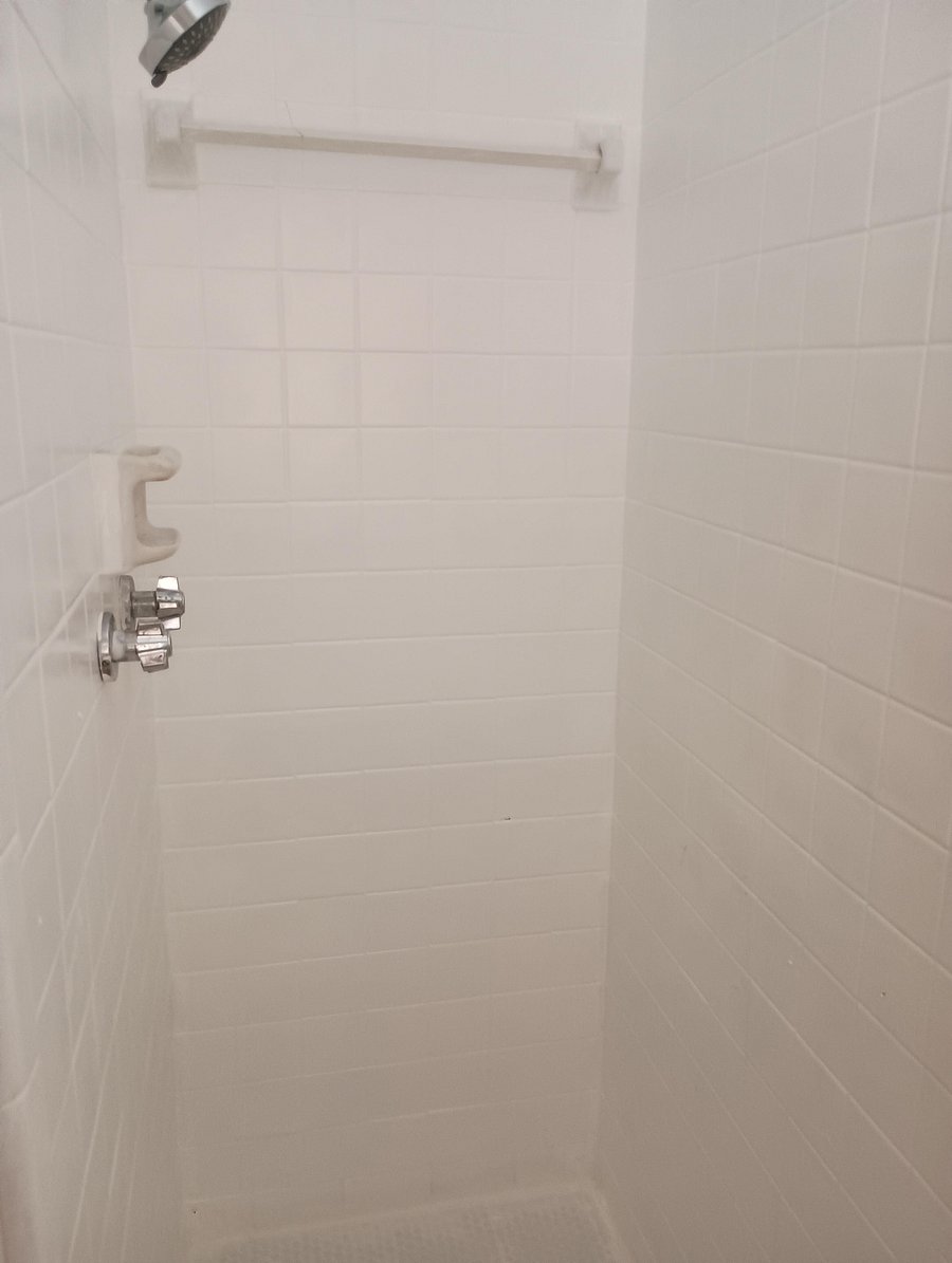 Shower with soap tray, towel rack and curtains for privacy