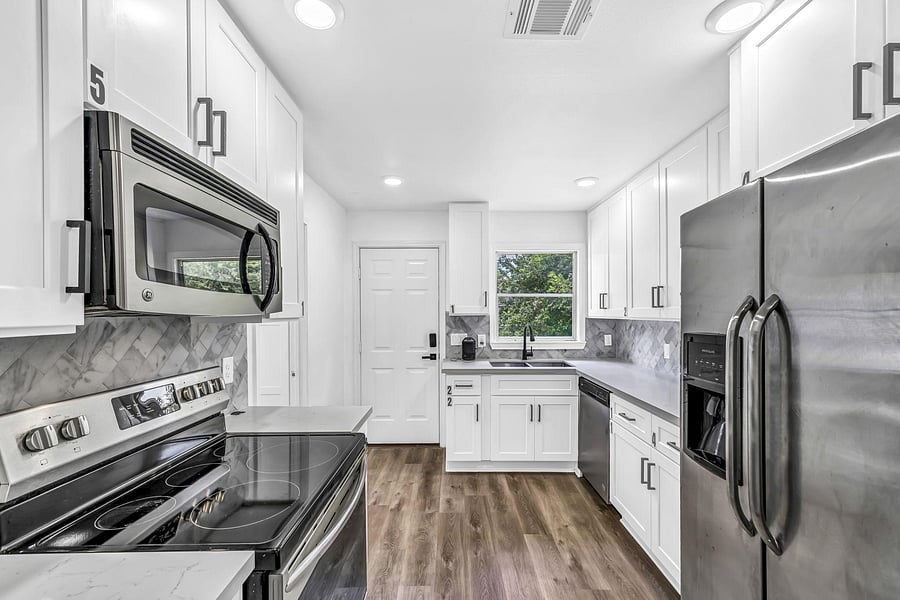Kitchen has a back exterior door that is also the shared main entry door. All members enter from the back kitchen door.