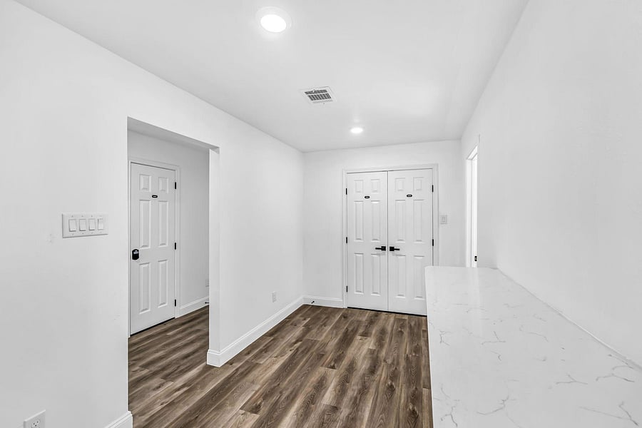 Small hallway leads to the shared open dining hall with counter top bar.