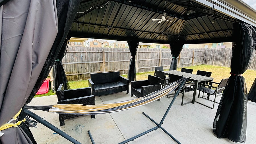 Fully furnished with couches, a dining table, and a hammock. Perfect for relaxing or working outdoors.