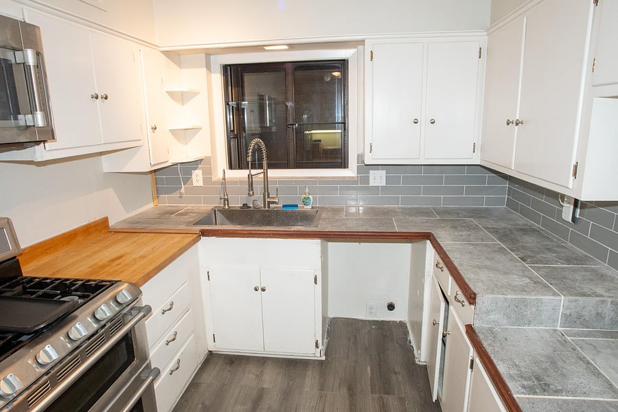 Full kitchen features plenty of cabinet space with a microwave, stove, oven, and two refrigerators.