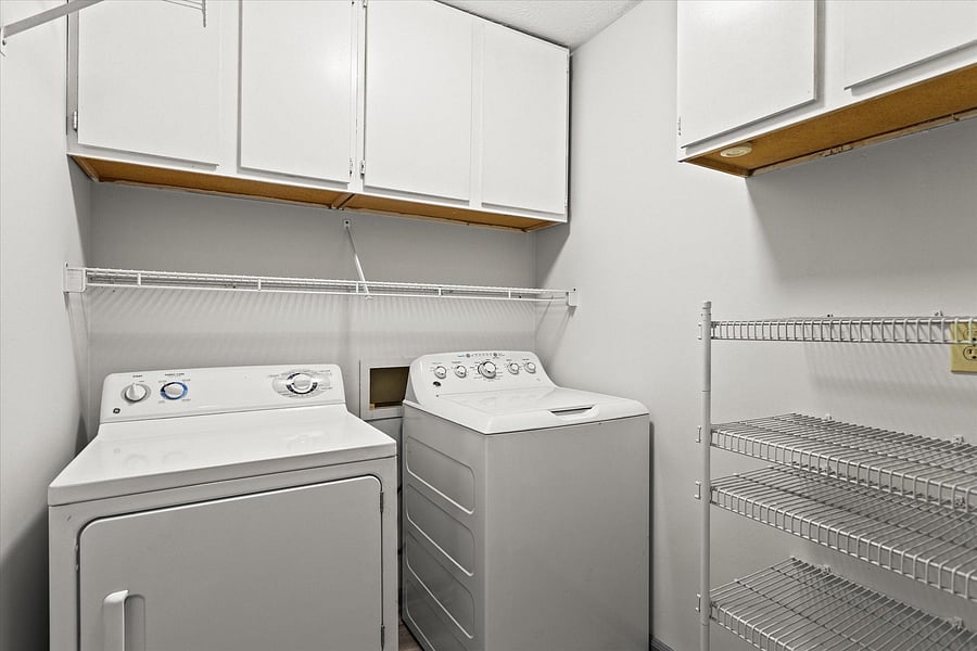 Upstairs laundry room equipped with washer and dryer.