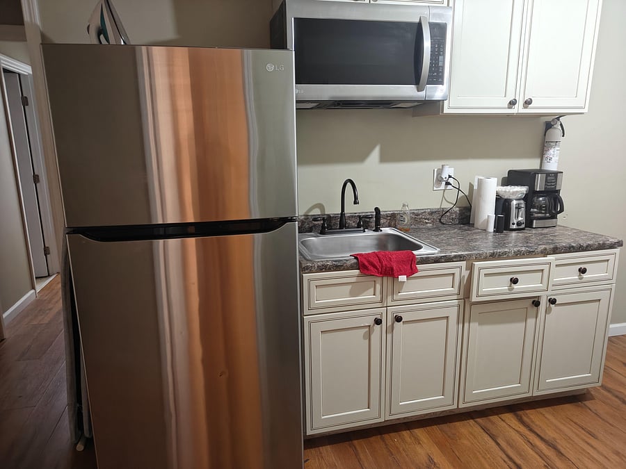 Shared kitchenette outside door. Full shared kitchen upstairs.