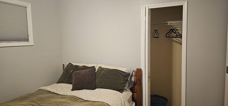 Queen bed with shared bathroom