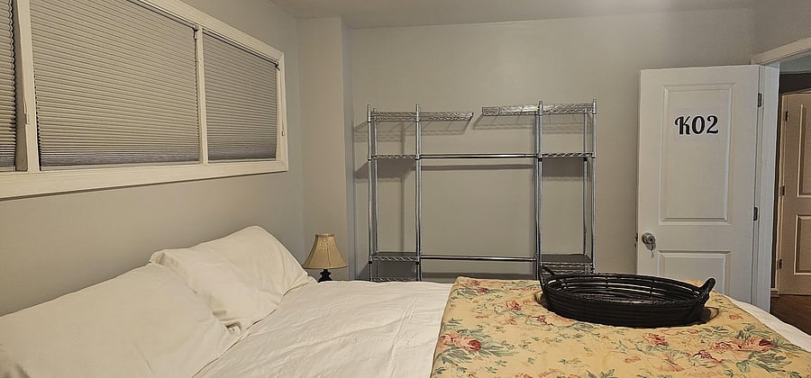 Deluxe California King bed with shared full bathroom