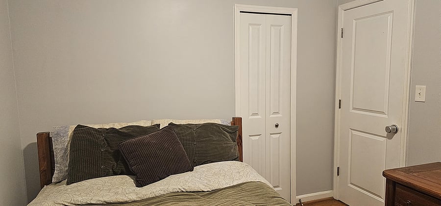 Queen bed with shared bathroom