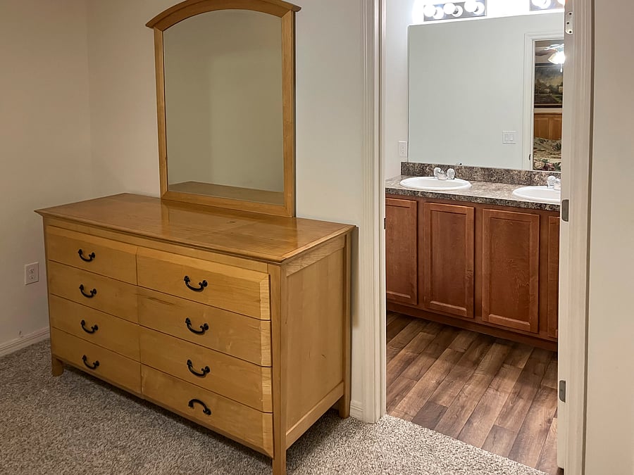 Dresser and entrance to private bath