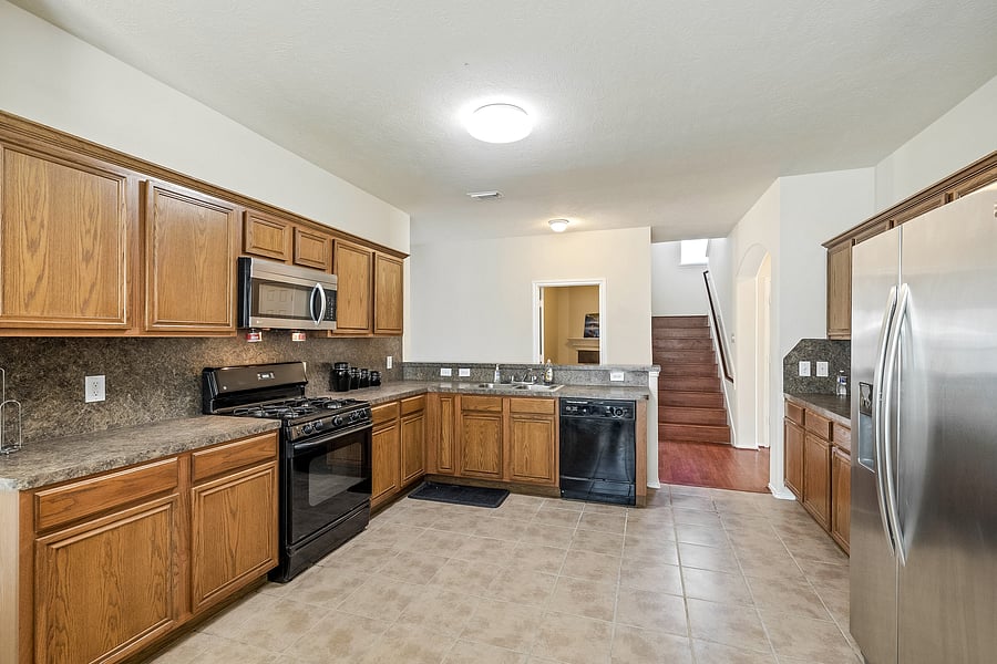 Enjoy some grub in this gorgeous and spacious open concept kitchen with gas stove and stainless steel refrigerator!