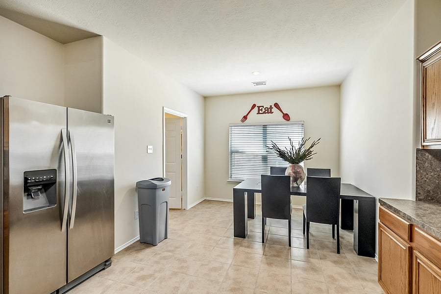 Enjoy some grub in this gorgeous and spacious open concept kitchen with gas stove and stainless steel refrigerator!