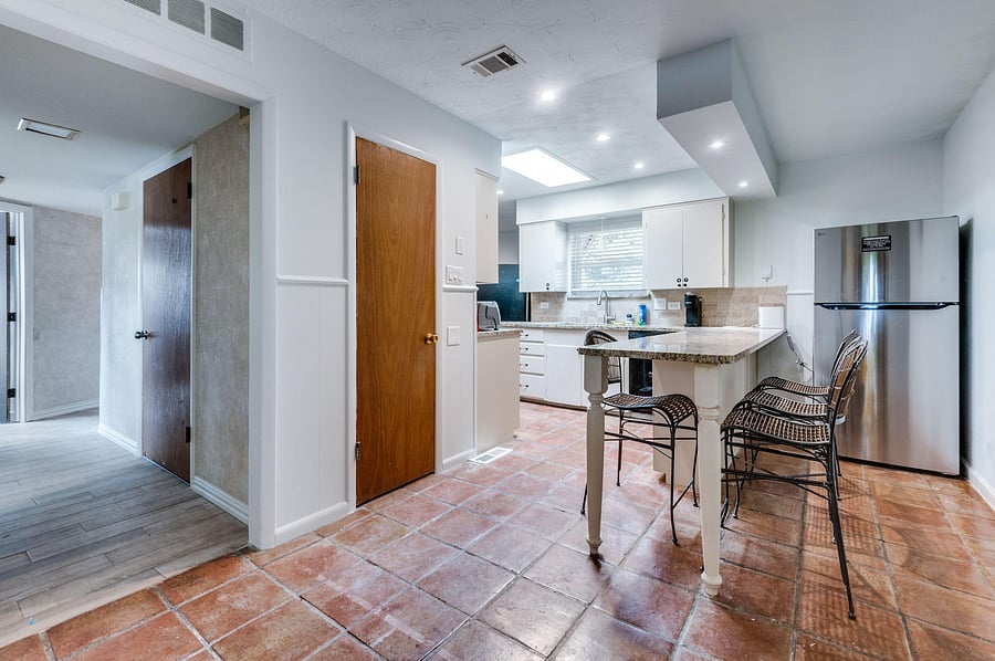Warm tiles, granite tops, and good vibes -- this kitchen feels like home